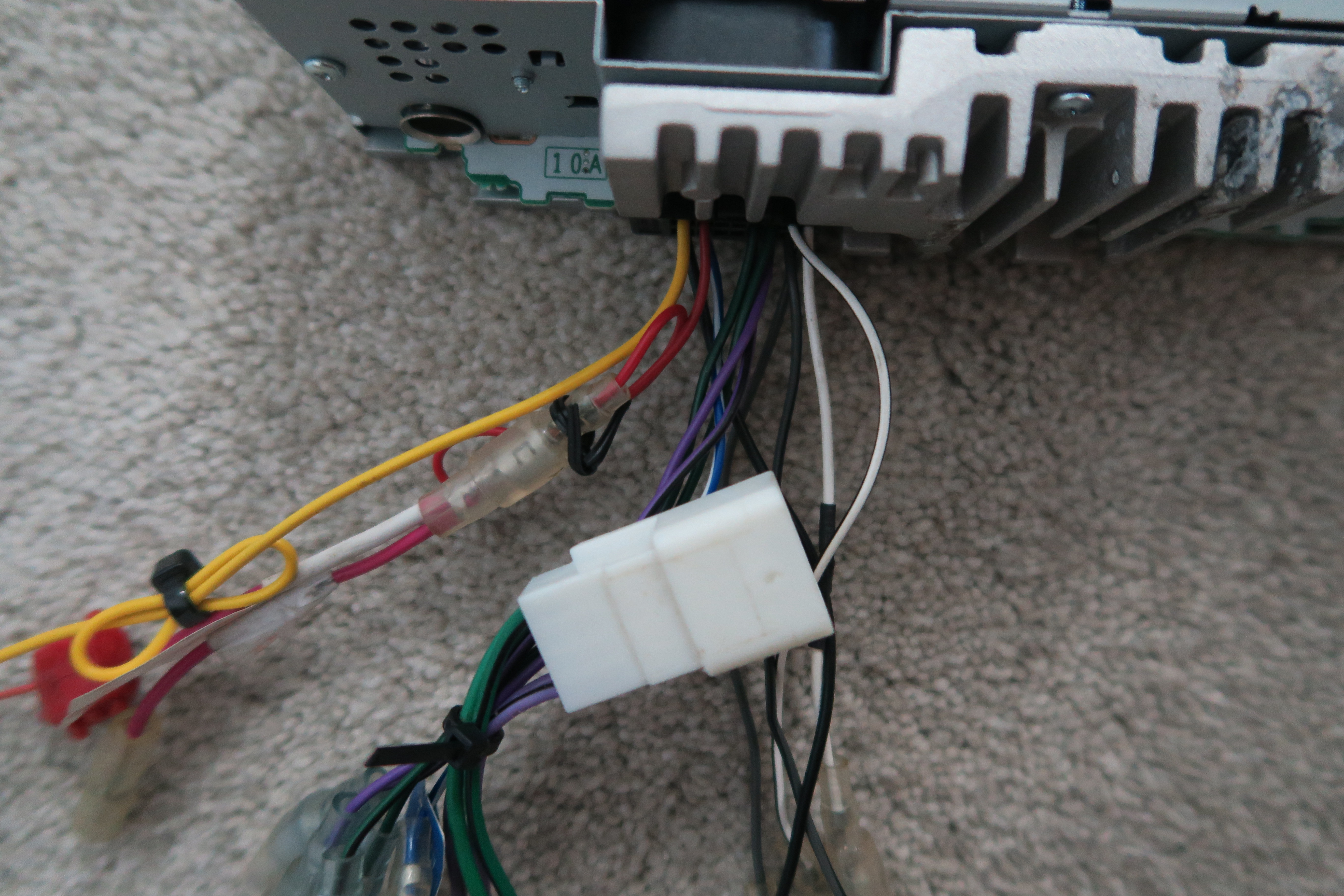 A close up of the wires coming out of the stereo.